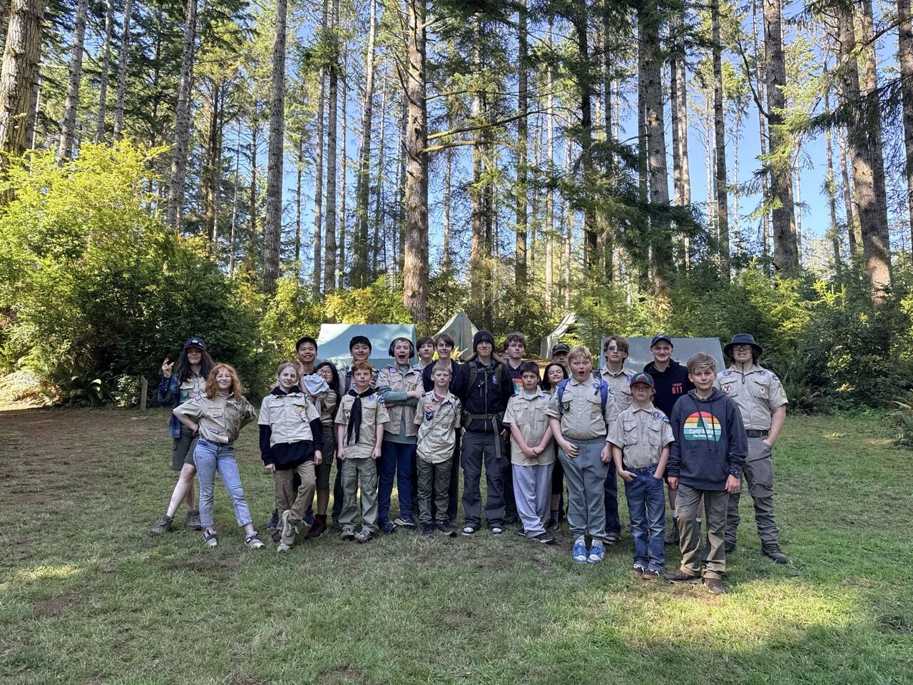 Troops 611 and 5611 group photo in the forest at Camp Baker