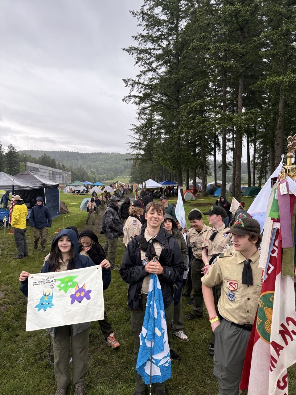Scouts carrying troop flags and banners at the Camporee ceremony